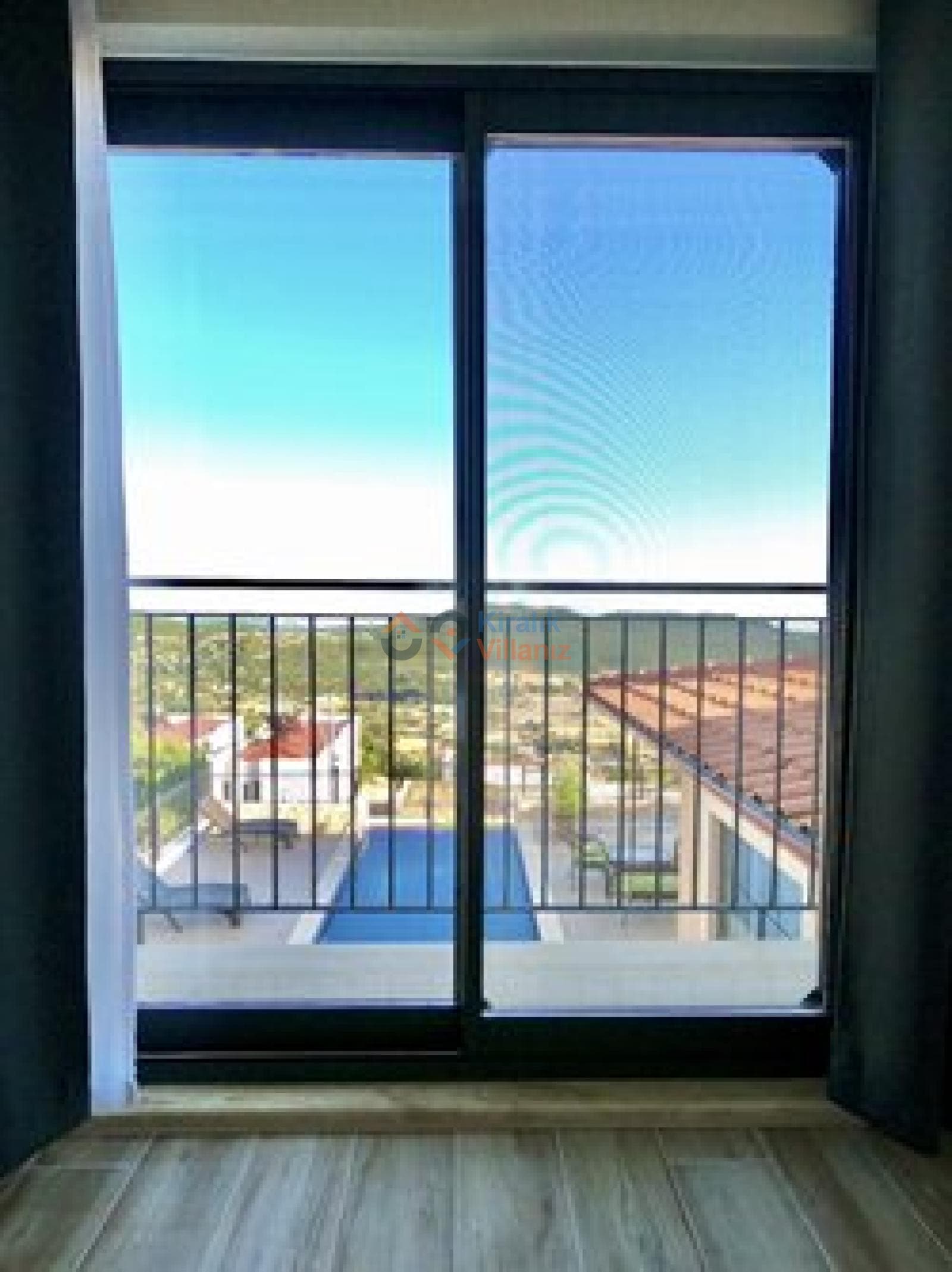 Balkon kapısından görünen doğa manzarası ve açık havuz.