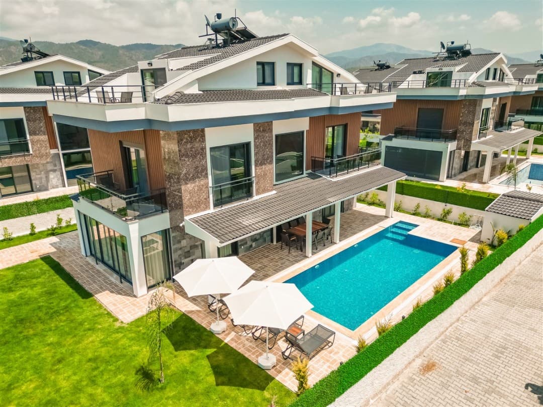 Özel havuzlu, bahçeli, balkonlu ve güneş şemsiyeli modern mimariye sahip müstakil villa.