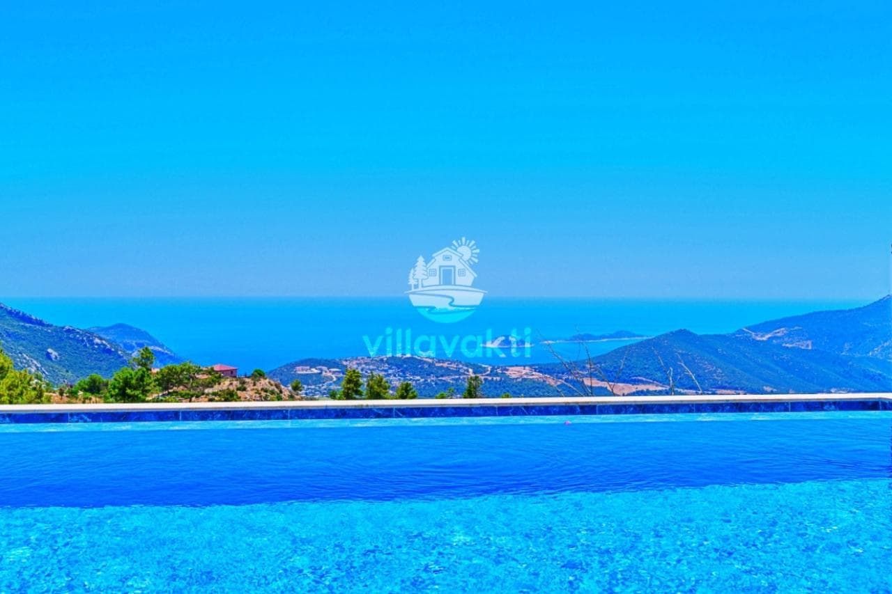 Havuz kenarından dağlar ve deniz uzanan geniş manzara